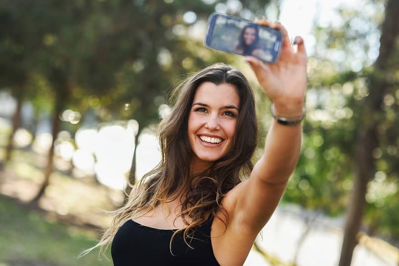 woman taking photos with mobile