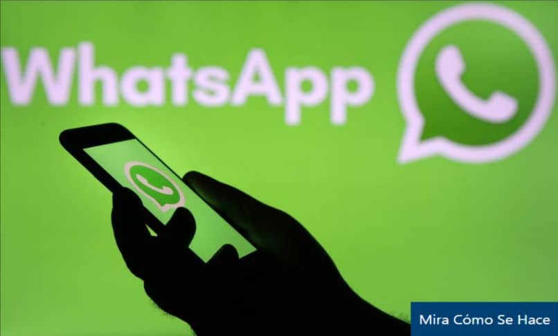 celular mano logo whatsapp fondo verde