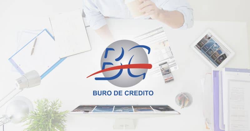 buro de credito logo background of man in office in front of screen and with tablet on table