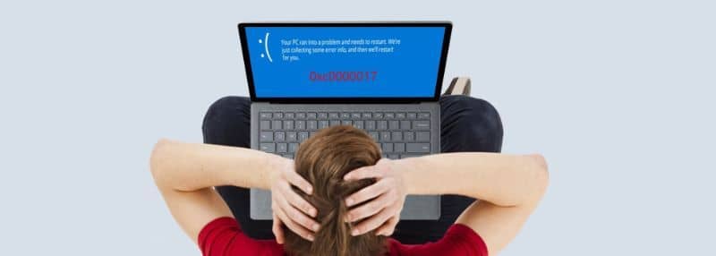 person holding his head seeing error on laptop