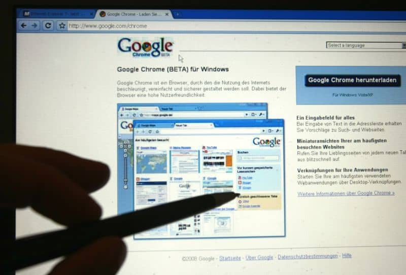 pc screen with google chrome and hands pointing with a pencil