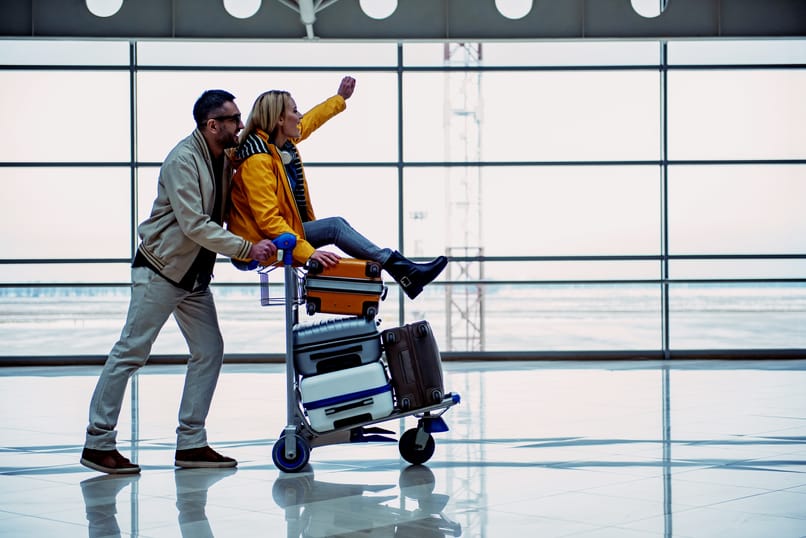 pareja lleva maletas en aeropuerto